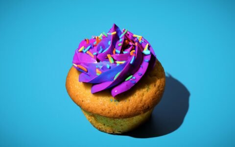 a cupcake with purple frosting and sprinkles